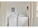 Laundry closet with washer and dryer, fire extinguisher and electrical panel at 128 51St St # A, Holmes Beach, FL 34217