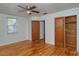 Bedroom with hardwood floors, ceiling fan and built-in closet at 1330 Cocoanut Ave, Sarasota, FL 34236