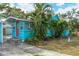 Cute bungalow with a red door and palm trees at 1330 Cocoanut Ave, Sarasota, FL 34236