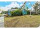 Charming light blue house with red door and green lawn at 1330 Cocoanut Ave, Sarasota, FL 34236