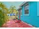 Bright blue house exterior with red door and pink patio at 1330 Cocoanut Ave, Sarasota, FL 34236