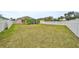 Large backyard with grassy area and white vinyl fence at 1479 Blue Horizon Cir, Bradenton, FL 34208