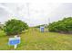 Small dog park with grass, trees and a gate at 1479 Blue Horizon Cir, Bradenton, FL 34208