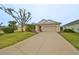 Single-story house with a two-car garage and well-manicured lawn at 1479 Blue Horizon Cir, Bradenton, FL 34208