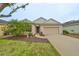 Front view of a single-story house with a garage and landscaping at 1479 Blue Horizon Cir, Bradenton, FL 34208