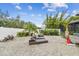 Landscaped backyard with lounge chairs and tropical plants at 1604 21St W Ave, Palmetto, FL 34221