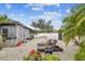 Spacious backyard with gravel ground cover and tropical plants at 1604 21St W Ave, Palmetto, FL 34221