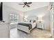 Spacious bedroom with white furniture and ceiling fan at 1604 21St W Ave, Palmetto, FL 34221