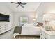 Bedroom with white dresser and large TV at 1604 21St W Ave, Palmetto, FL 34221