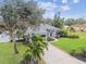 House exterior showcasing landscaping and a large driveway at 1604 21St W Ave, Palmetto, FL 34221