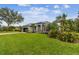 Single-Gathering home with grey exterior and palm trees at 1604 21St W Ave, Palmetto, FL 34221