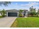 Gray house with black garage and landscaped yard at 1604 21St W Ave, Palmetto, FL 34221