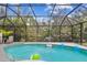 Inviting screened pool with deck and water feature at 1604 21St W Ave, Palmetto, FL 34221