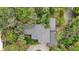 Aerial view of a house surrounded by lush greenery at 1702 Spoonbill Dr, Nokomis, FL 34275