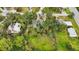 Aerial view showing home's location in a wooded neighborhood at 1702 Spoonbill Dr, Nokomis, FL 34275