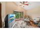 Cozy bedroom with a view, featuring a comfortable armchair and large TV at 1702 Spoonbill Dr, Nokomis, FL 34275