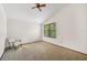 Spacious bedroom with carpeted floor, large window, and ceiling fan at 1702 Spoonbill Dr, Nokomis, FL 34275