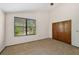 Bright bedroom featuring a large window, double closet, and ceiling fan at 1702 Spoonbill Dr, Nokomis, FL 34275