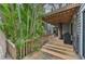 Wooden deck with tree, spiral staircase, and grill at 1702 Spoonbill Dr, Nokomis, FL 34275