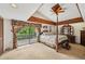 Large main bedroom with a king-size bed, access to a deck, and high ceilings at 1702 Spoonbill Dr, Nokomis, FL 34275