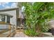 A spiral staircase leading to a deck, surrounded by tropical landscaping at 1702 Spoonbill Dr, Nokomis, FL 34275