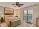 Spacious bedroom with a king-size bed and sliding doors to balcony at 1783 Lake Pl # 1783B, Venice, FL 34293