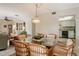 Bright dining room with kitchen view and stylish chandelier at 1783 Lake Pl # 1783B, Venice, FL 34293