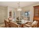 Bright dining room with glass-top table and wicker chairs at 1783 Lake Pl # 1783B, Venice, FL 34293