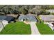 Aerial view of a well-maintained property with a lush green lawn and fenced backyard at 1817 New London St, North Port, FL 34288