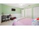 Bedroom with light green walls, ceiling fan, and tiled floors at 1817 New London St, North Port, FL 34288