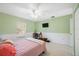 Bedroom with light green walls, ceiling fan, and tiled floors at 1817 New London St, North Port, FL 34288