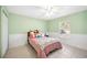 Bedroom with light green walls, ceiling fan, and tiled floors at 1817 New London St, North Port, FL 34288