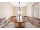 Dining room features abundant natural light, rustic wood accent wall, and stylish chandelier at 1817 New London St, North Port, FL 34288