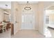 Bright and airy foyer with tile flooring, chandelier, and a decorative front door at 1817 New London St, North Port, FL 34288