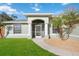 Inviting front entrance featuring a screened porch, decorative columns and well-maintained landscaping at 1817 New London St, North Port, FL 34288