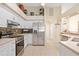 This kitchen is equipped with stainless steel appliances and mosaic tile backsplash at 1817 New London St, North Port, FL 34288