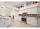 The kitchen is equipped with modern appliances and white cabinetry, adjacent to a utility room at 1817 New London St, North Port, FL 34288