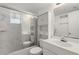 Bright bathroom featuring a shower-tub combo, white vanity, and mirrored wall cabinet at 1853 Restful Dr # L2, Bradenton, FL 34207