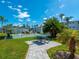 Community area with a picnic table and a tennis court set among the palm trees at 1853 Restful Dr # L2, Bradenton, FL 34207