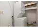 Stackable washer and dryer in a small laundry closet with shelving at 1853 Restful Dr # L2, Bradenton, FL 34207