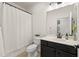 Clean bathroom with a shower/tub combo, toilet, and dark vanity at 19256 Jalisca St, Venice, FL 34293