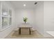 Light and airy dining area with a wooden table and benches at 19256 Jalisca St, Venice, FL 34293