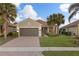 Single story house with brown garage door and palm trees at 19256 Jalisca St, Venice, FL 34293