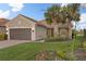 One-story house with a brown garage door and lush landscaping at 19256 Jalisca St, Venice, FL 34293