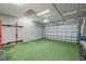 Finished garage with artificial turf flooring, ideal for a gym or workshop at 19256 Jalisca St, Venice, FL 34293