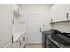 Bright laundry room with modern appliances, ample counter space, and white cabinets at 19256 Jalisca St, Venice, FL 34293