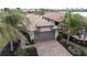 Property showcasing a brick driveway and lush landscaping, with a view of neighboring homes at 19261 Isadora St, Venice, FL 34293