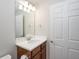 Simple bathroom with white vanity and a large mirror at 19261 Isadora St, Venice, FL 34293