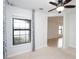 Bedroom with window, carpet, ceiling fan and access to another room at 19261 Isadora St, Venice, FL 34293