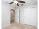 Spacious bedroom with ceiling fan and double closets at 19261 Isadora St, Venice, FL 34293